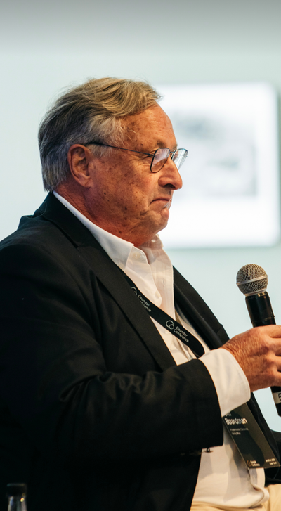 Speaker stands with microphone in hand